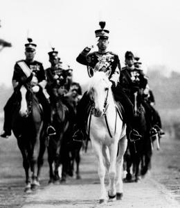 FILE - In this 1937 file photo, Japan's Emperor Hirohito salutes from his mount, his favorite white horse, during a military review in Tokyo. The original recording of Japan's Emperor Hirohito's war-ending speech has come back to life in digital form. The original sound was released Saturday, Aug. 1, 2015 by the Imperial Household Agency in digital format, ahead of the 70th anniversary of the speech and the war's end. (AP Photo/File)